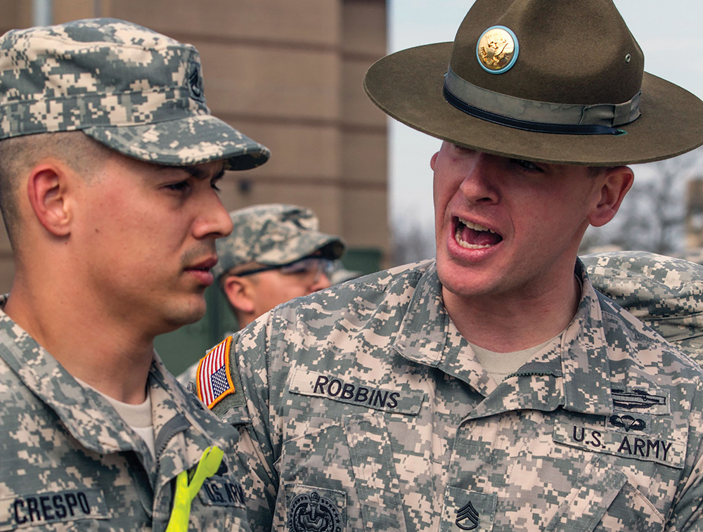 Drill sergeant candidates from the active component Army, Army Reserve and National Guard receive on-the-spot corrections from Staff Sgt. Logan Robbins, a drill sergeant leader, on “zero day” at the U.S. Army Drill Sergeant Academy at Fort Jackson, S.C. (Photo by Sgt. 1st Class Brian Hamilton)
