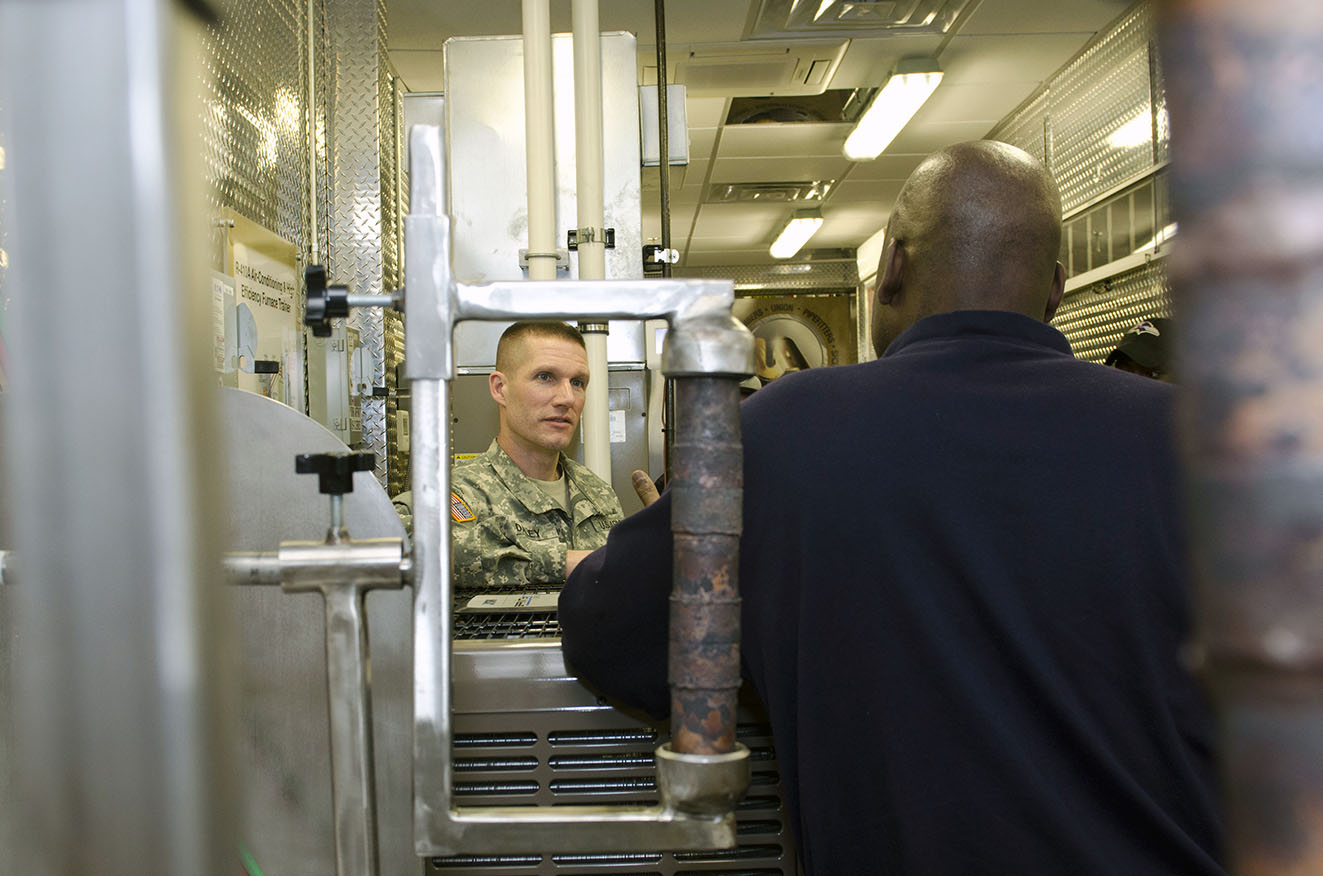 William McLaurin, a representative from the JBLM HVAC training program, briefs Sgt. Maj. of the Army Daniel Dailey on the HVAC Program during Dailey’s visit to JBLM on March 2. Dailey toured the HVAC Trailer after meeting with students from the program. (Photos by Sgt. Ryan Hallock)