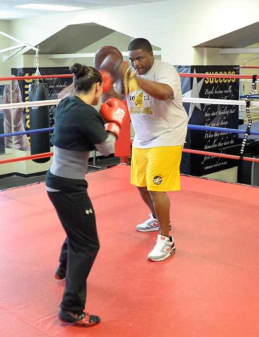 Staff Sgt. Charles Leverette, right, works the mitts with Spc. Alex Love in Fort Carson, Colorado. Leverette is the outgoing head boxing coach of the U.S. Army World Class Athlete Program.