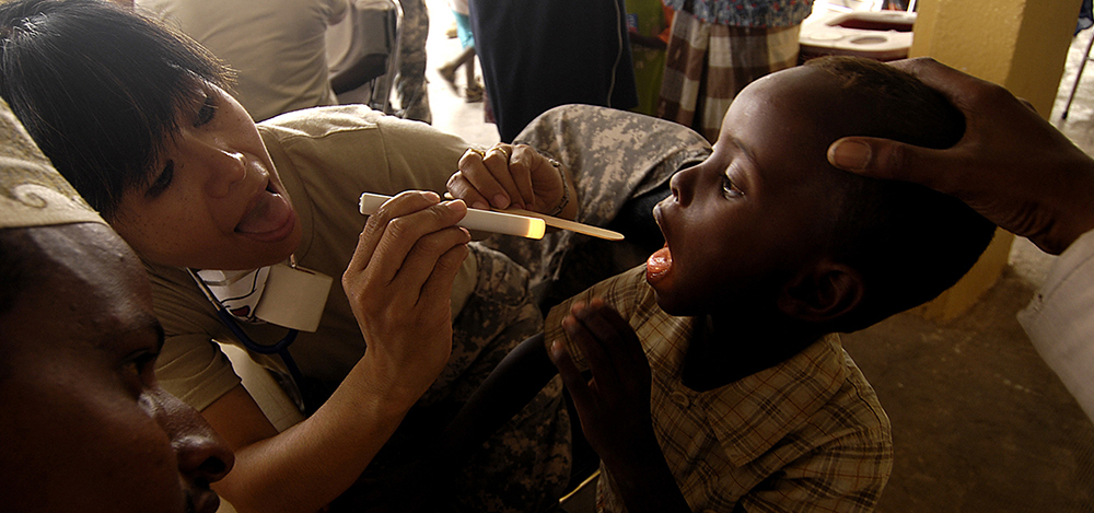 Sgt. 1st Class Marites Cabreza, a nurse with 354th Civil Affairs Brigade, Special Functioning Team, Combined Joint Task Force–Horn of Africa, tends to a patient March 29, 2008, during a medical civil action project in Goubetto, Djibouti. (U.S. Air Force photo by Tech. Sgt. Jeremy T. Lock)