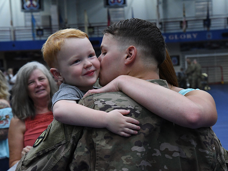 A Soldier with 2nd Brigade Combat Team, 10th Mountain Division reunites with his family after a deployment