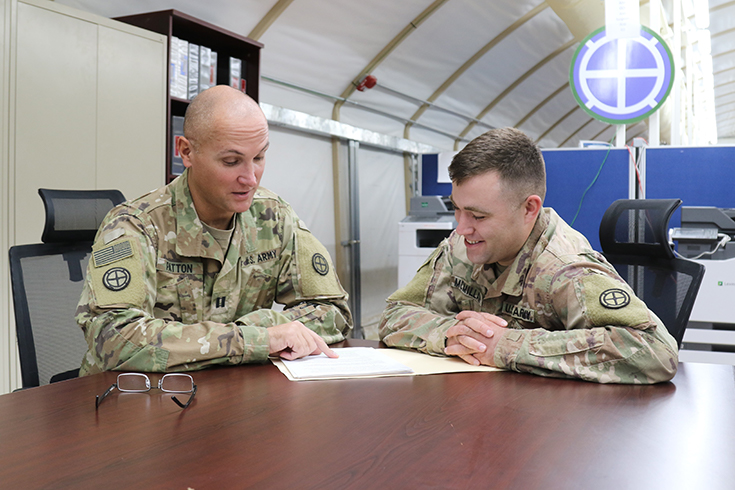 U.S. Army Staff Sgt. Michael McMillan, 35th Infantry Division, behavioral health noncommissioned officer in charge, confers with Capt. Trever Patton