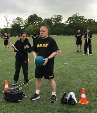 A U.S. Army Soldier prepares to toss a 10-pound medicine ball over his head as part of the Standing Power Throw event of the Army Combat Fitness Test. (Photo courtesy of Maj. Brad Cooper)