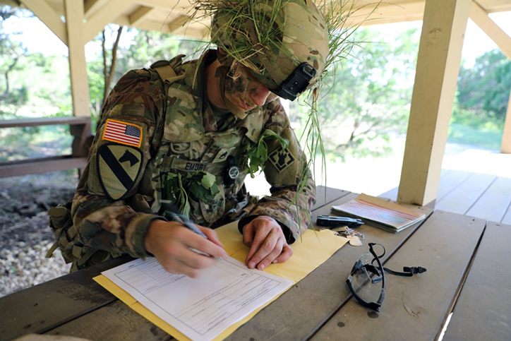 U.S. Army Staff Sgt. Billy Emory writes a situational report during the Army Futures Command Best Warrior Competition