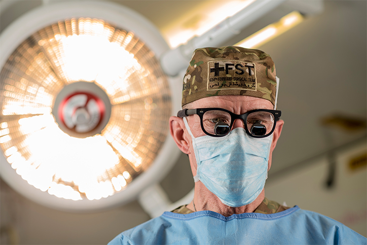 Col. Jay Johannigman, a U.S. Army Reserve general surgeon, poses for a portrait while wearing a pair of binocular loupes