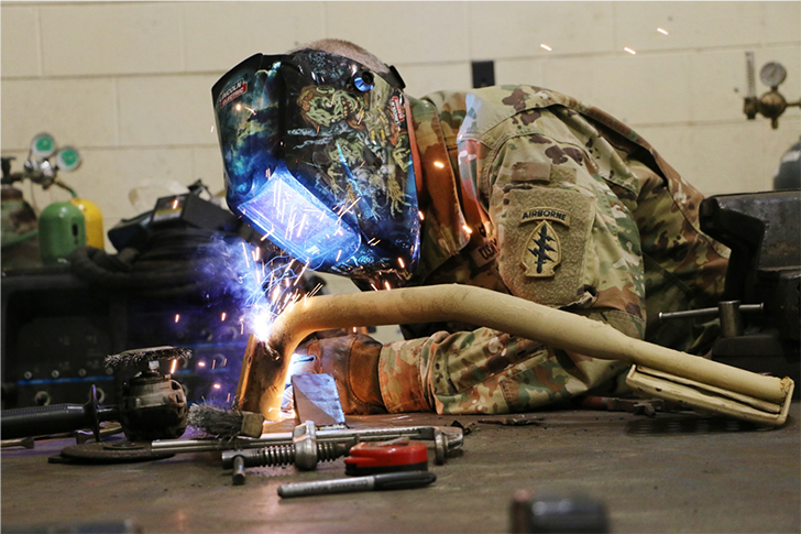 Chief Warrant Officer Mike Cox, the Bravo Company Allied Trades Warrant Officer, conducts metal repair at Fort Bragg, NC, June, 2017