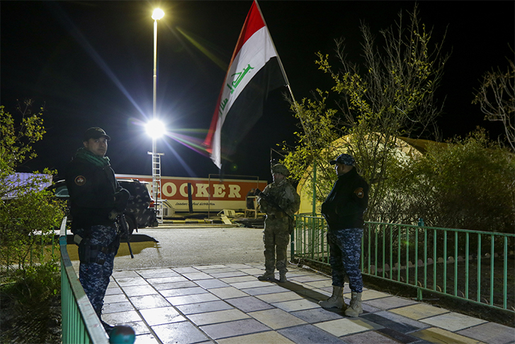 U.S. Army Paratrooper and Iraqi federal policeman guard the entrance to the Combined Joint Operations Center.