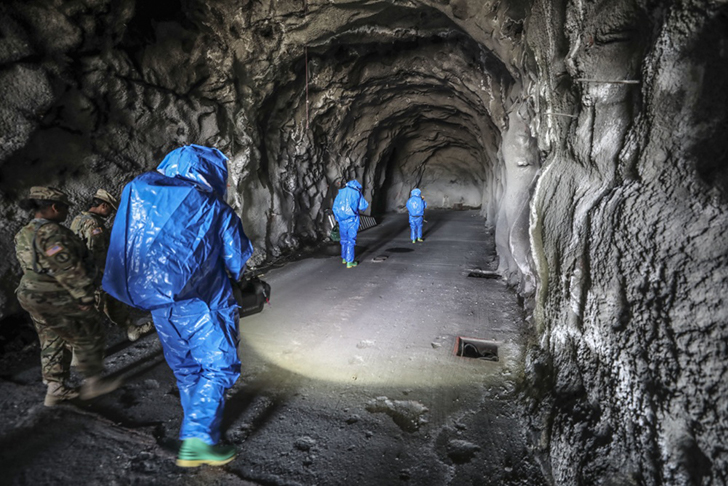 A group of Army Reserve Soldiers from the 327th Chemical Company, 92nd Chemical Battalion, 415th Chemical Brigade, 76th Operational Response Command enter a tunnel to conduct reconnaissance of a suspected chemical weapons cache during a training exercise at Dugway Proving Ground, Utah, June 20, 2019. 