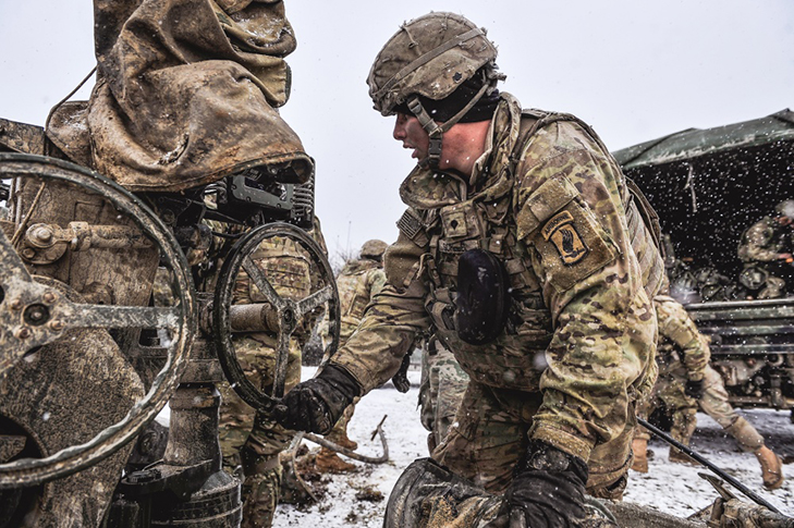 Paratroopers assigned to Chaos Battery, 4th Battalion, 319th Field Artillery Regiment, 173rd Airborne Brigade prepare their M777 howitzer