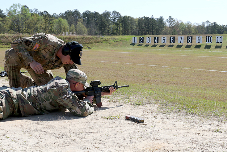 U.S. Army Staff Sgt. Brad Balsley, a shooter/instructor with the U.S. Army Marksmanship Unit's Instructor Training Group works with a drill sergeant of 2nd Squadron