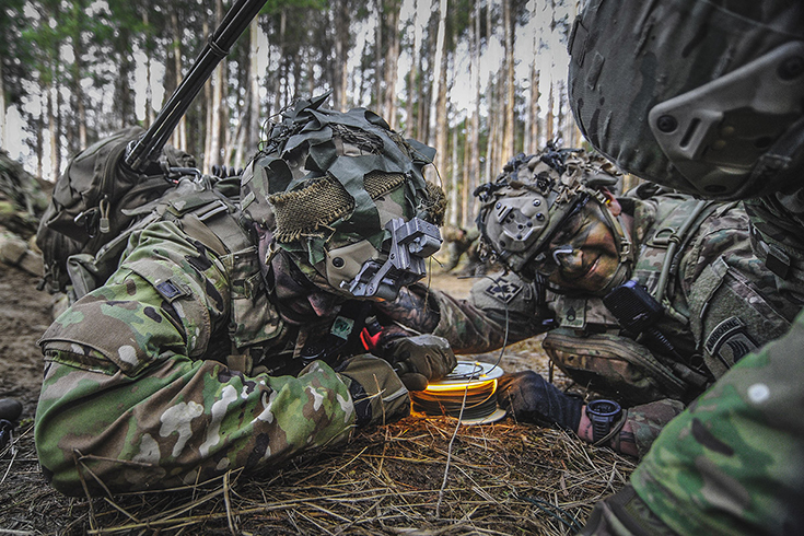 Paratroopers assigned to the 173rd Airborne Brigade, pull an M81 igniter to detonate a brazier charge during Exercise Rock Spring