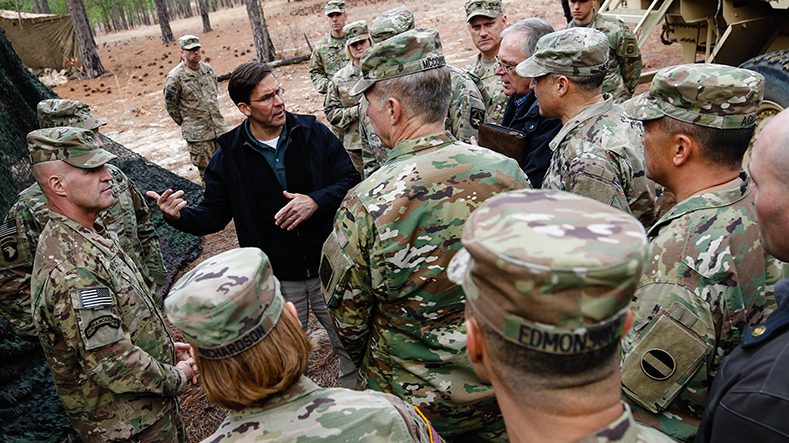 Secretary of the Army Dr. Mark T. Esper discusses the tactical use of military equipment with senior members of the U.S. Army