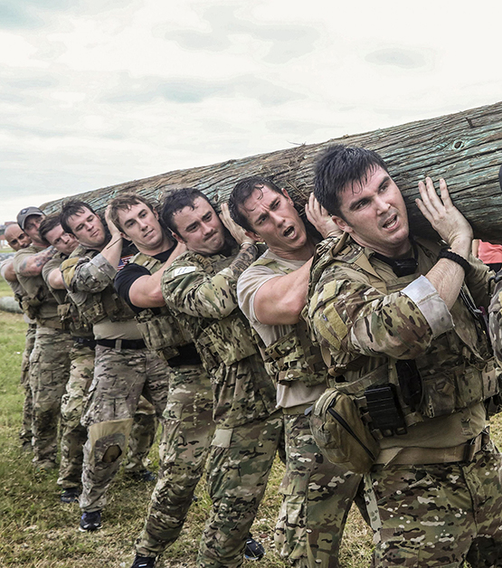 Soldiers lift a log during a battalion endurance event at Torii Station, Okinawa, on Nov. 30, 2017