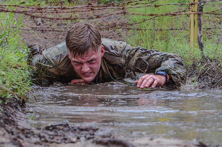 a paratrooper navigates a low-crawl obstacle