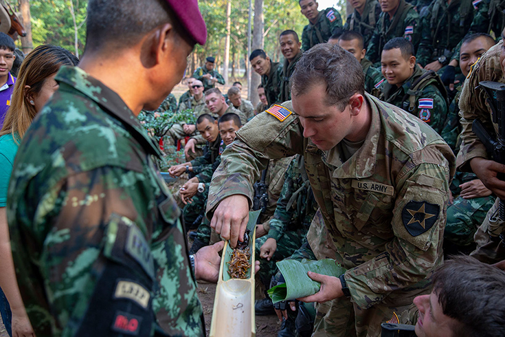 a paratrooper navigates a low-crawl obstacle