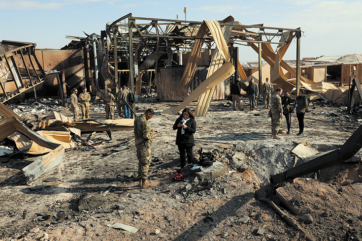 Media outlets visit one of the many impact sites created by the recent missile attacks at Al Asad Air Base, Iraq