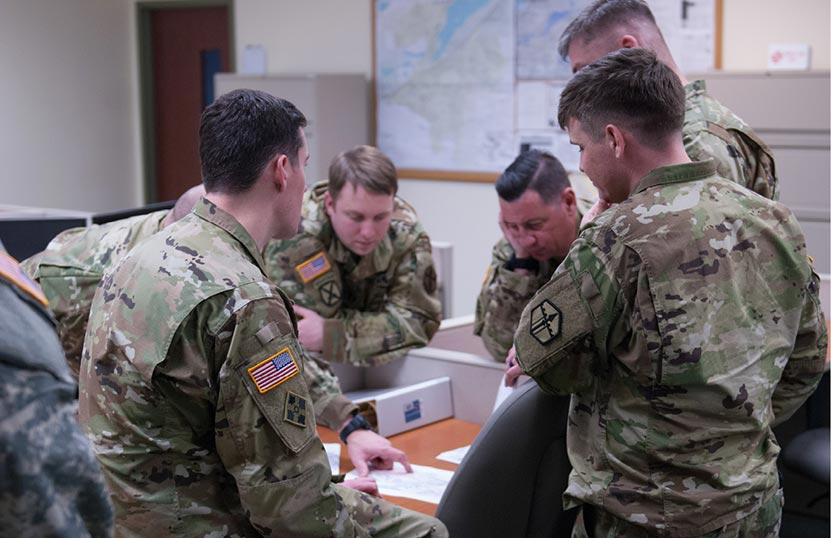 Key leadership from the 301st Maneuver Enhancement Brigade reviews a route before a convoy takes place at Schwab Army Reserve Center