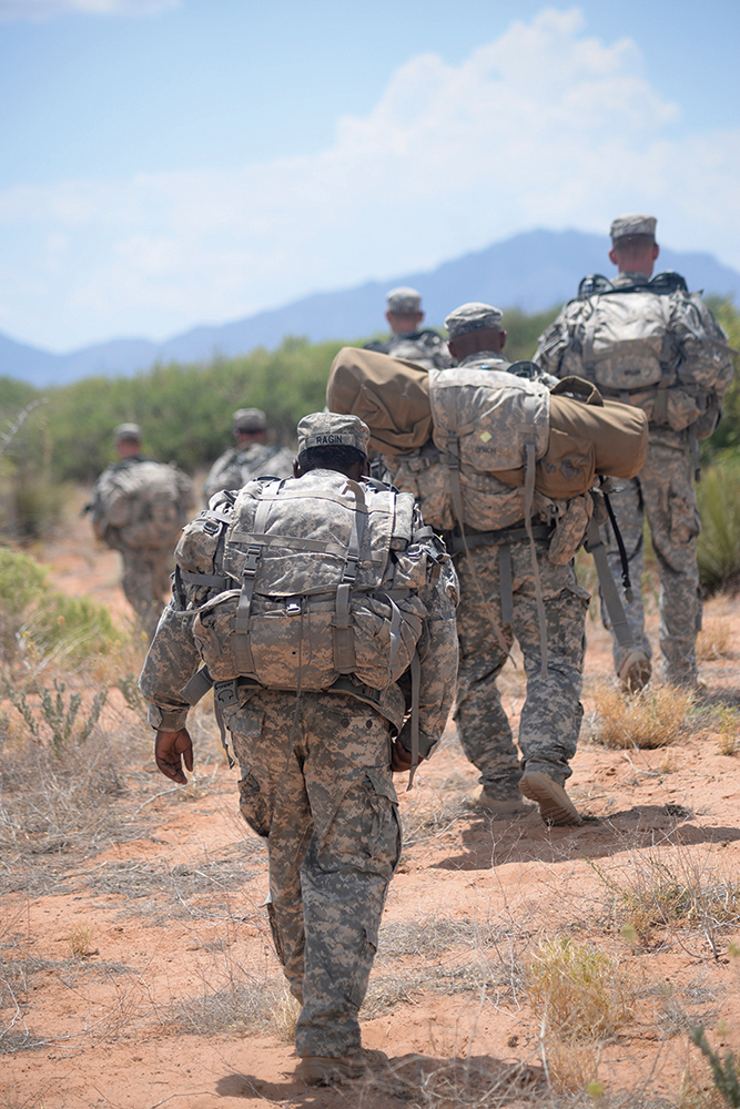 Staff Sgt. Cory Ragin, an instructor for the new Desert Warrior course at Fort Bliss, Texas, rucks behind his squad during a field exercise. (Photo by Meghan Portillo/NCO Journal)