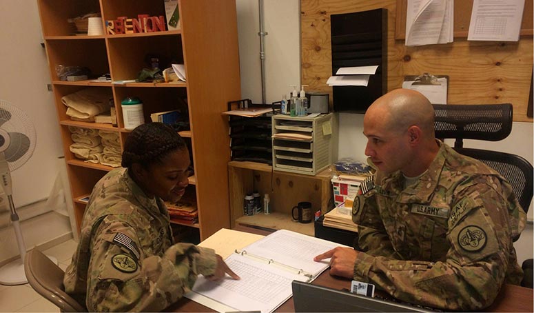 U.S. Army Sgt. 1st Class Pedro Leon (<i>right</i>) provides career advice and counseling to U.S. Army Sgt. Kareena Collins, Aug. 25, 2014.