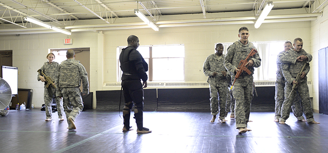 Sgt. Ivy Barton, center in black padding, watches as Soldiers go through drills during a combatives course as part of training conducted by the Aviation Mission Readiness Integration Company at Fort Carson, Colo. (Photo by Pablo Villa)