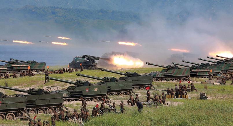 Korean People’s Army personnel launch rockets August 2017