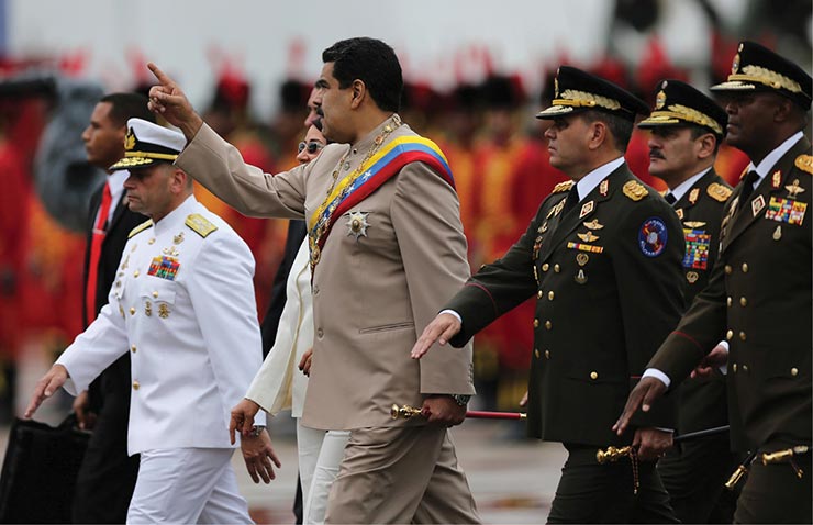 Venezuela's disputed President Nicolás Maduro carries the army commander’s baton 24 June 2017 as he arrives for Army Day celebrations at Fuerte Tiuna in Caracas, Venezuela.
