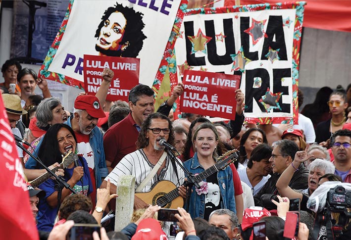 Workers’ Party President Gleisi Hoffmann (<em>center right</em>) attends a demonstration 7 April 2019—the anniversary of the incarceration of former Brazilian President Luiz Inácio Lula da Silva—outside the jail where Lula is being held in Curitiba, Brazil.