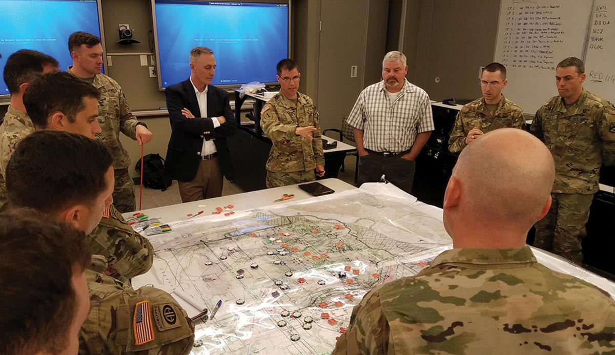 Maj. Matt Hill briefs Decisive Action Tactical Application Course instructors and fellow student brigade staff members during a decision briefing exercise 19 April 2017 at Fort Leavenworth, Kansas.