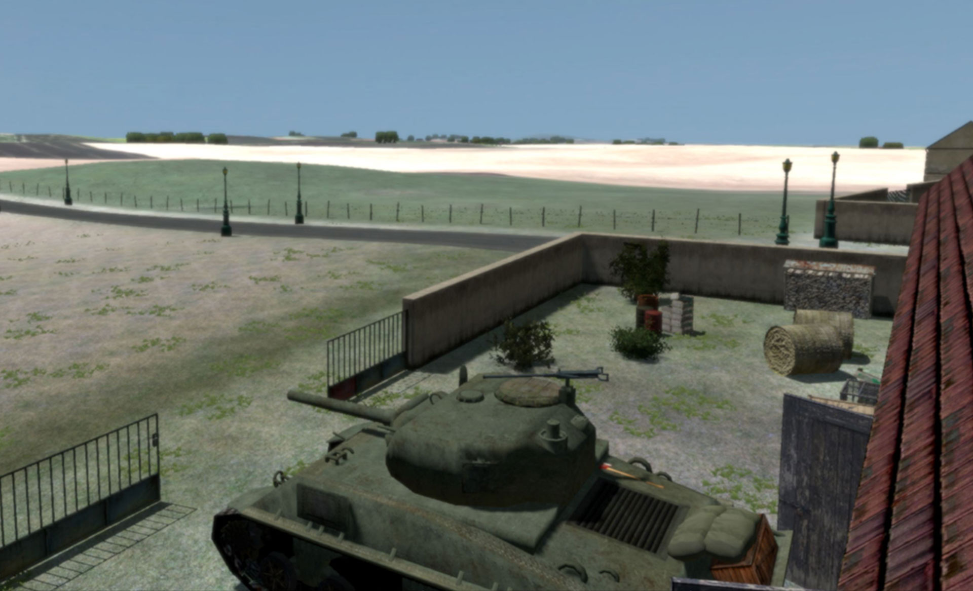 Computer-generated image of a Sherman tank in a walled courtyard near a rural road and field.