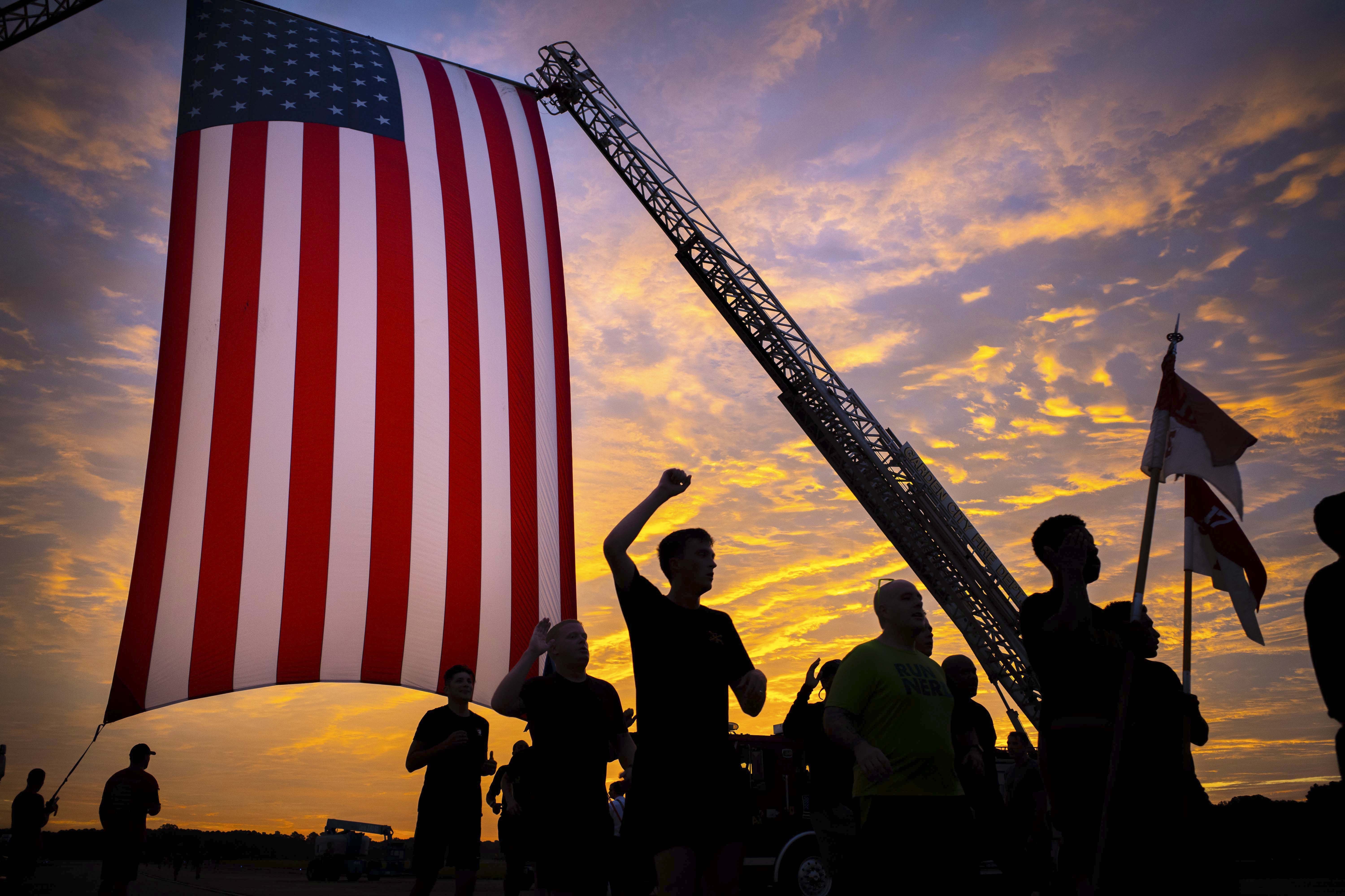 Soldiers cross the finish line during the installation’s 5K Patriot Day Run