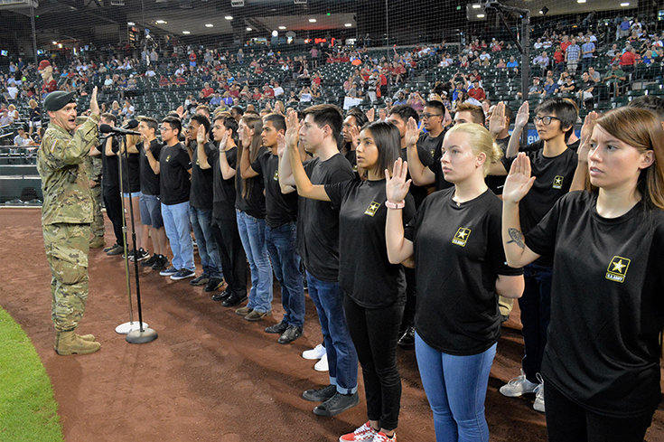 U.S. Army Lt. Col. Scott Morley, commander of the Phoenix Recruiting Battalion, administers the oath of enlistment to forty future soldiers 26 August 2018 at Chase Field in Phoenix