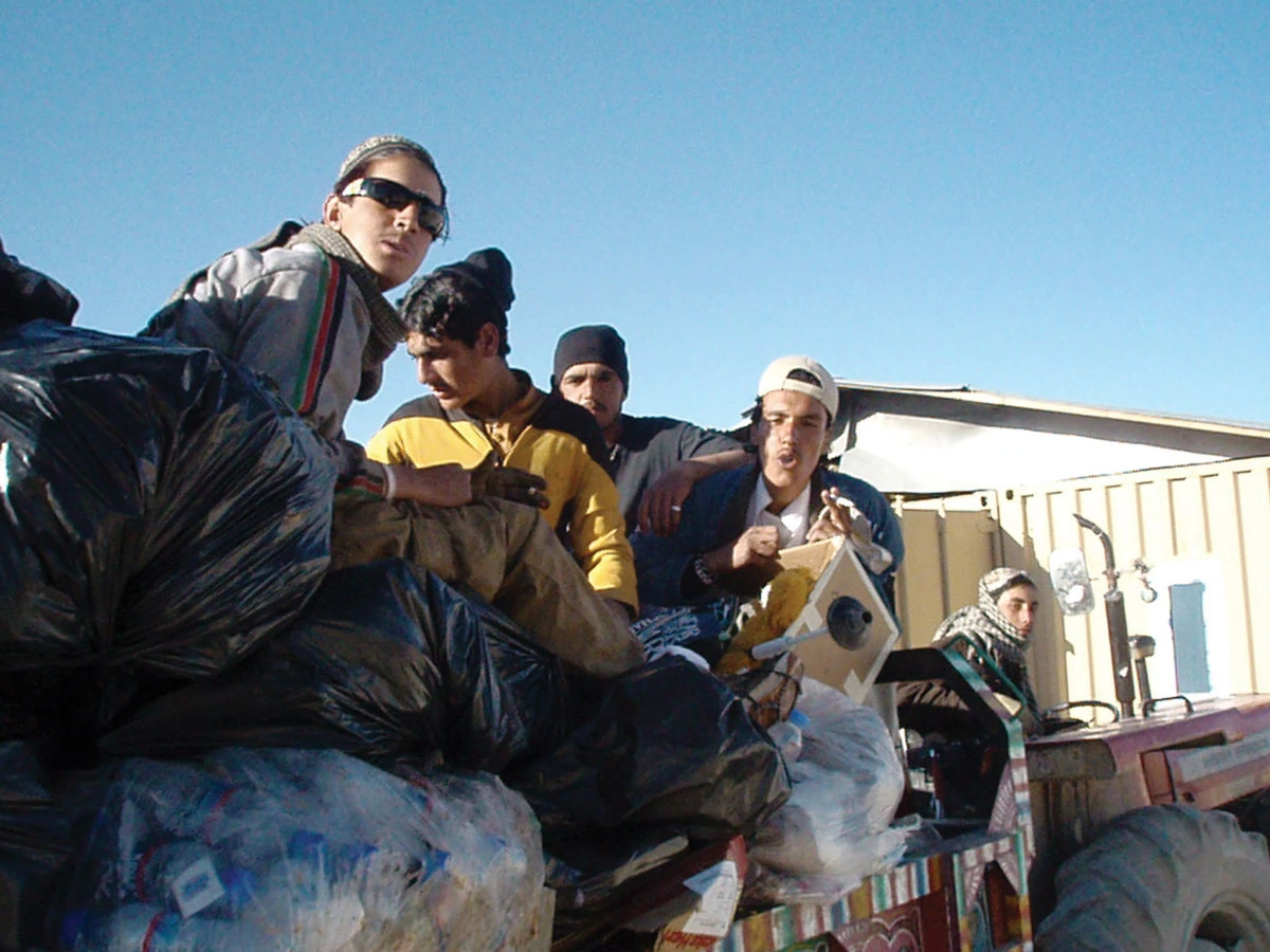 Young Afghan men who joined a garbage crew