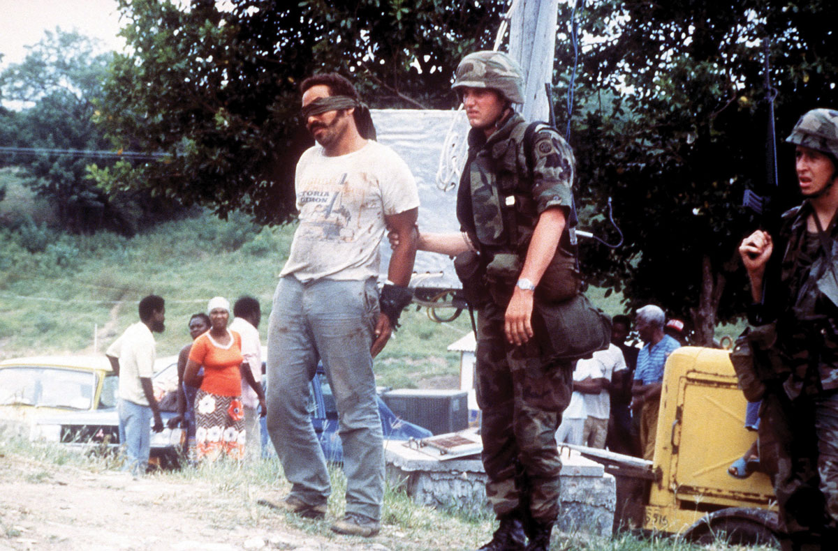 Members of the 82nd Airborne Division guard a blindfolded prisoner 25 October 1983 during Operation Urgent Fury in Grenada