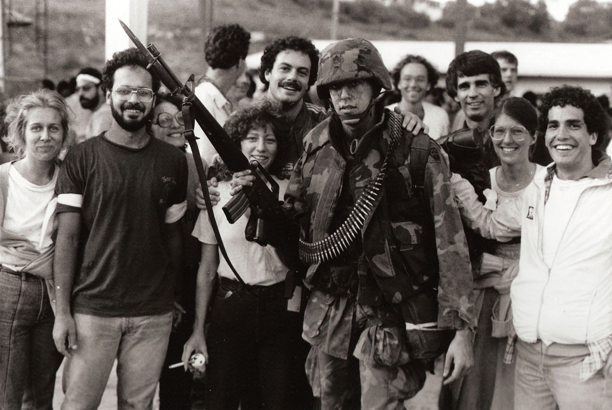 American medical students from the St. George’s Medical University surround an 82nd Airborne Division soldier after their liberation during the invasion of Grenada, codenamed Operation Urgent Fury, on 26 October 1983 in St. George’s, Grenada