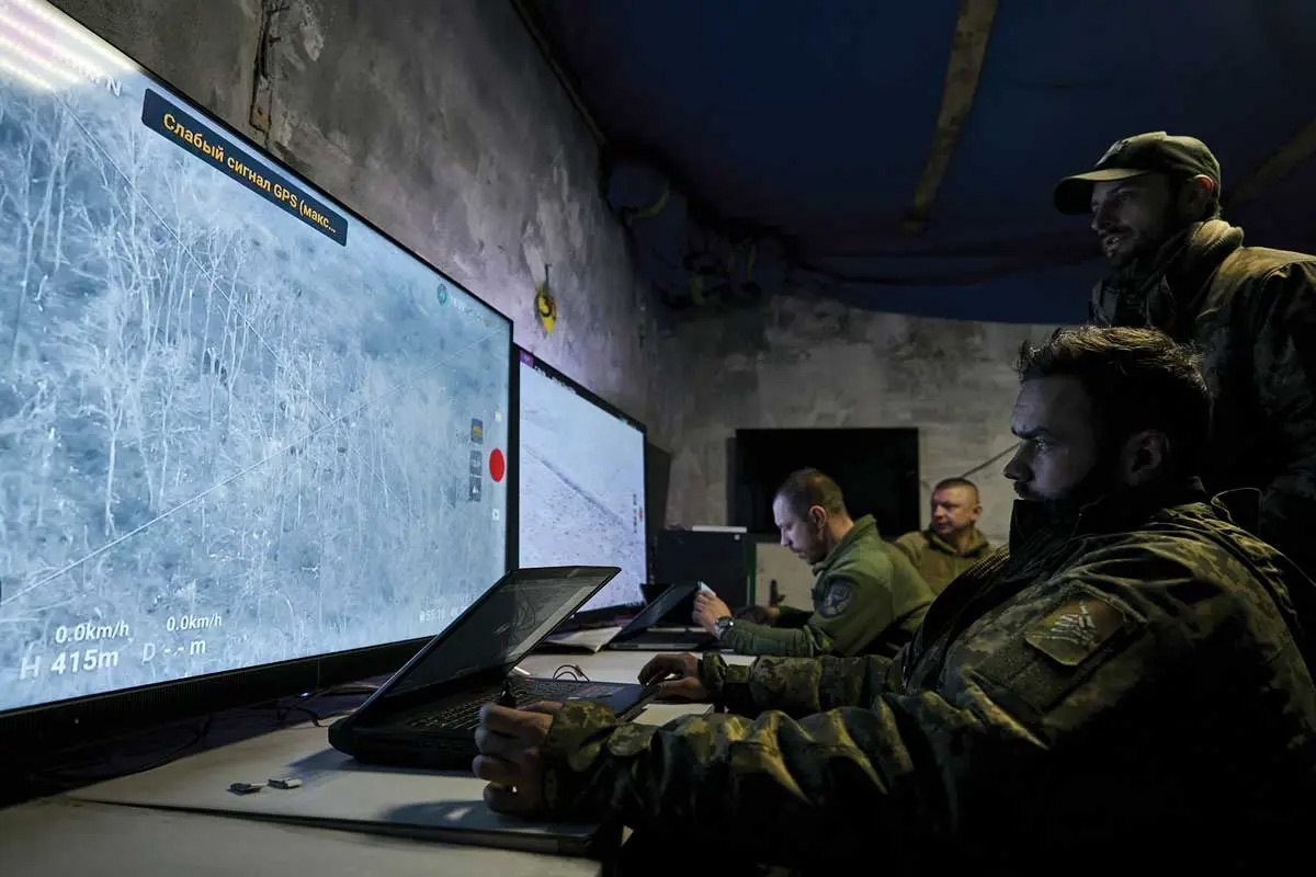 Ukrainian soldiers watch drone feeds from an underground command center in Bakhmut, Donetsk region, Ukraine, 25 December 2022