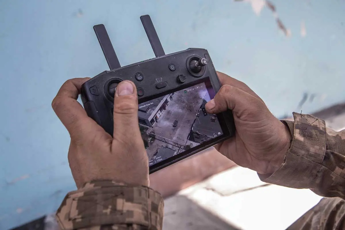 A Ukrainian soldier controls a drone as its camera shows Russian troop positions during heavy fighting at the front line in Severodonetsk, Luhansk region, Ukraine, 8 June 2022. (Photo by Oleksandr Ratushniak, Associated Press)