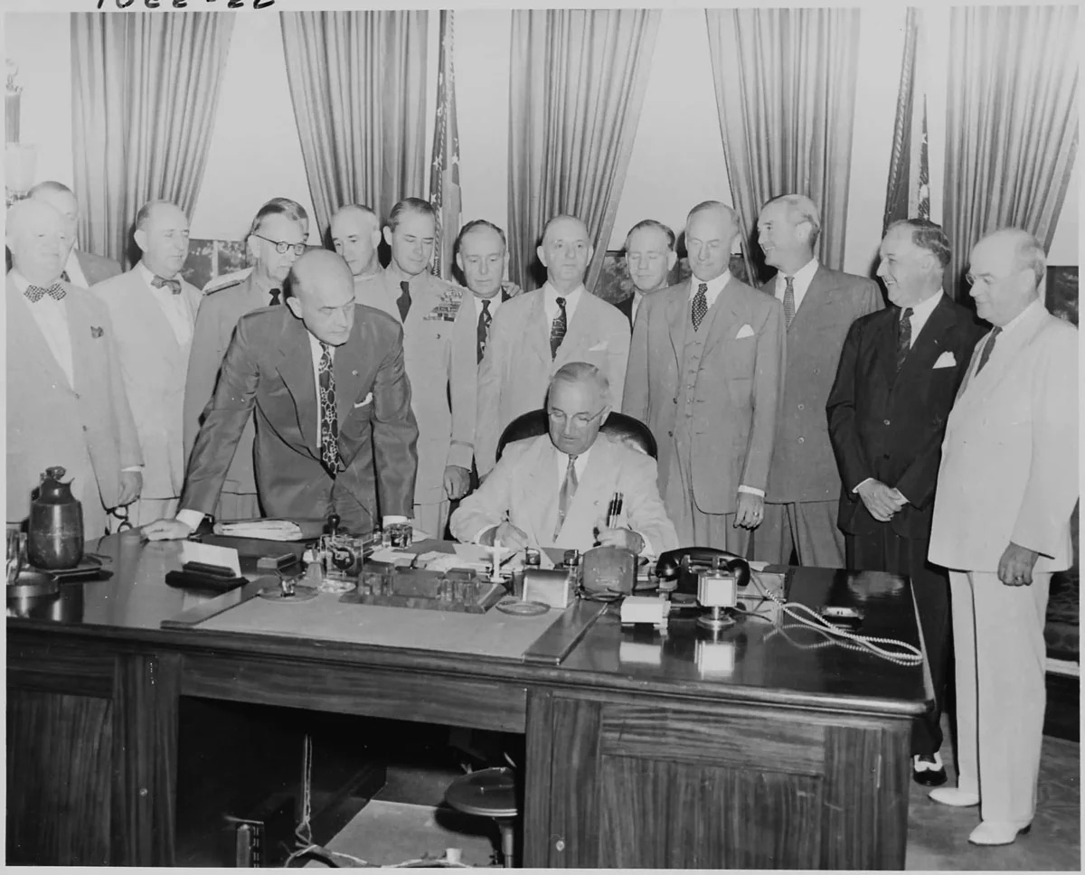 Various dignitaries witness President Harry S. Truman signing House Resolution
