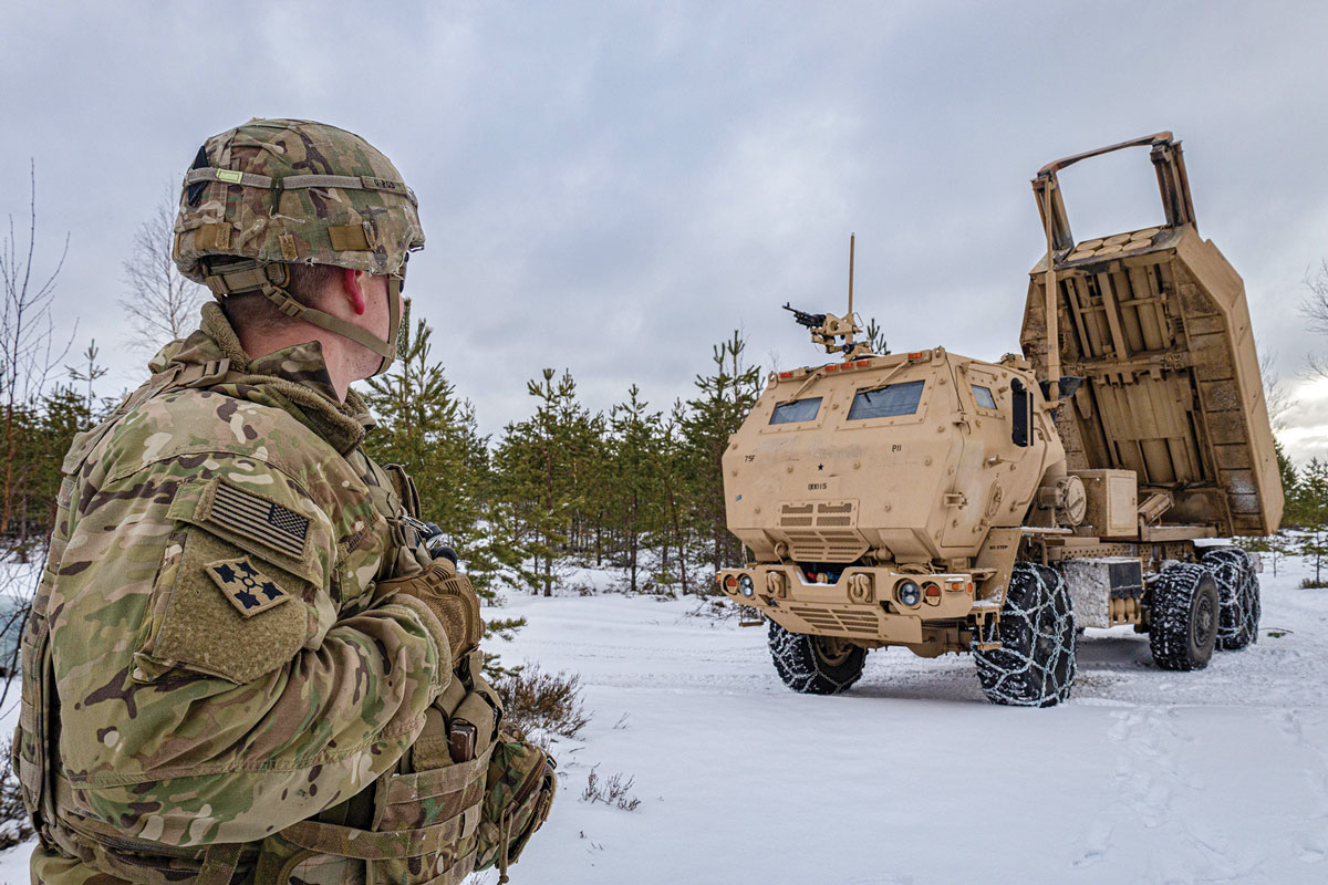 Capt. Dylan Karnedy, Bravo Battery commander for the 1st Battalion, 14th Field Artillery Regiment, 75th Field Artillery Brigade, stands in front of an M142 High Mobility Artillery Rocket System during a media demonstration 5 February 2023 at Tapa Army Base, Estonia