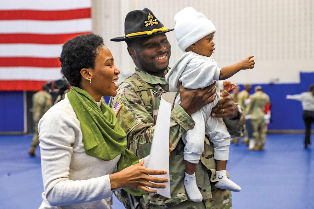 A soldier assigned to the 3rd Division Combat Aviation Brigade, 3rd Infantry Division, greets his family at Hunter Army Airfield