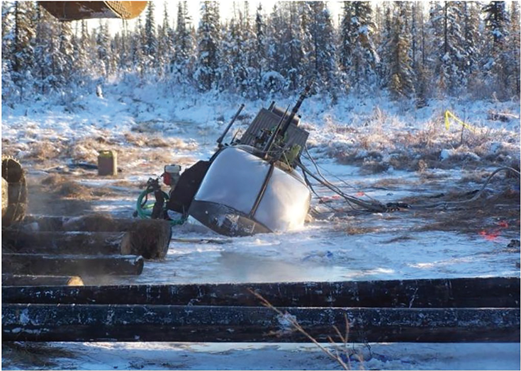 A military helicopter sits immobilized in muskeg