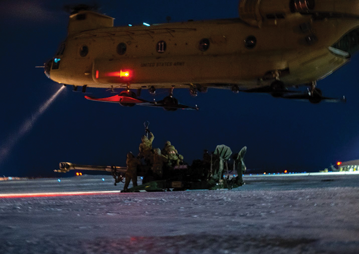 Artillery crewmembers from Battery B, 2nd Battalion, 8th Field Artillery Regiment, sling load a howitzer to a CH-47 helicopter