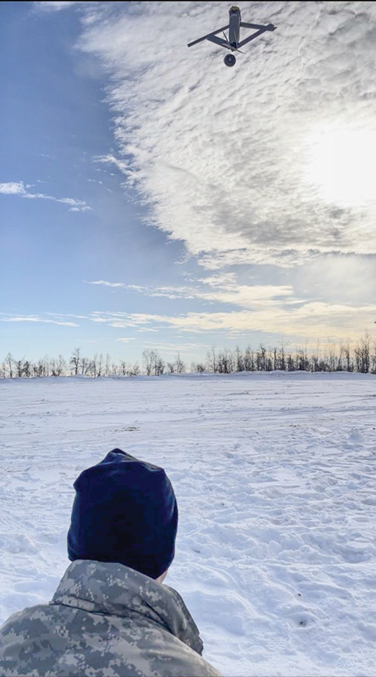 A fire support specialist from the 2nd Battalion, 8th Field Artillery Regiment, tests a Switchblade 300 precision strike unmanned aircraft system in extreme cold weather