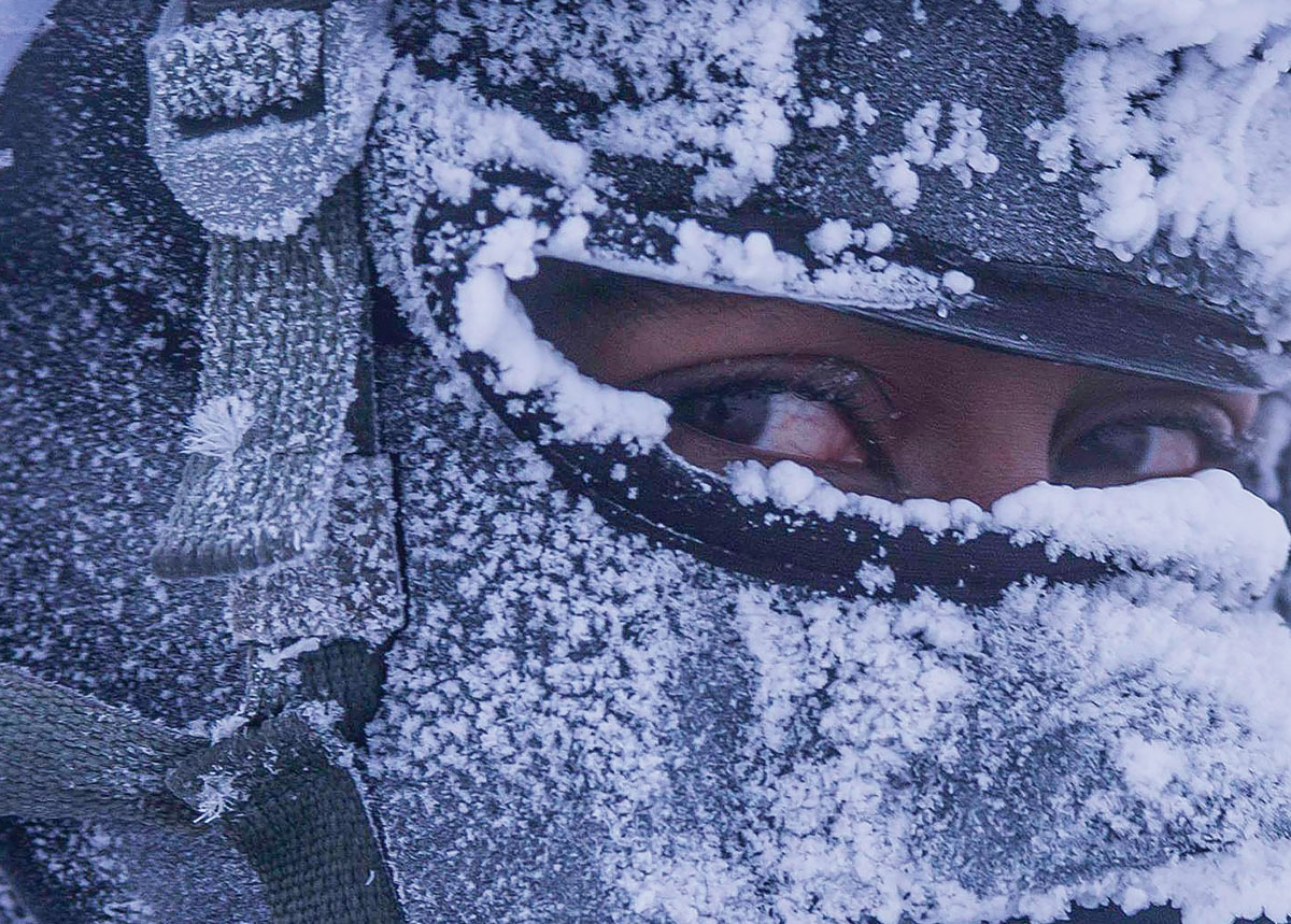 A paratrooper with 1st Squadron, 40th Cavalry Regiment, awaits transportation after a successful airborne operation and follow-on mission in Deadhorse, Alaska, 22 February 2017. The training simulated the recovery of a downed satellite and tested the unit's contingency operations ability