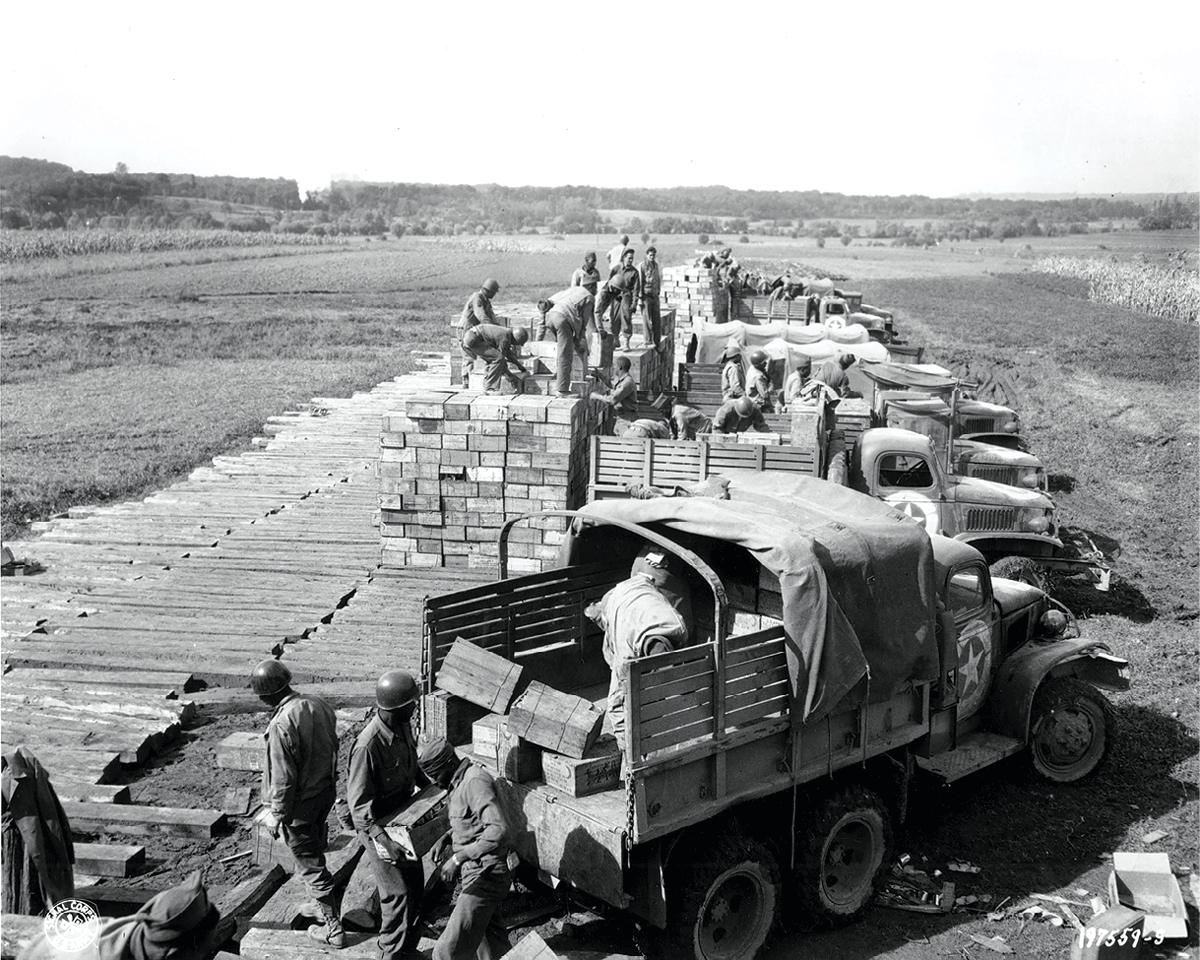 Soldiers load trucks with combat rations
