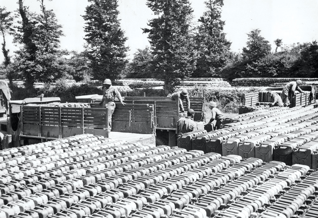 Trucks from different units draw cans of gasoline 7 February 1945