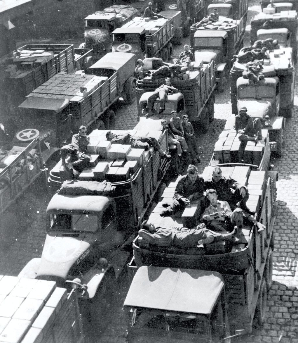 U.S. drivers nap or relax on boxes of ammunition and other equipment 10 October 1944