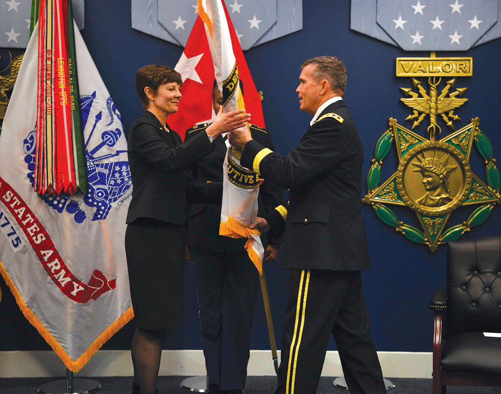 Carol Burton left, director of the Civilian Human Resources Agency, is presented a Senior Executive Service