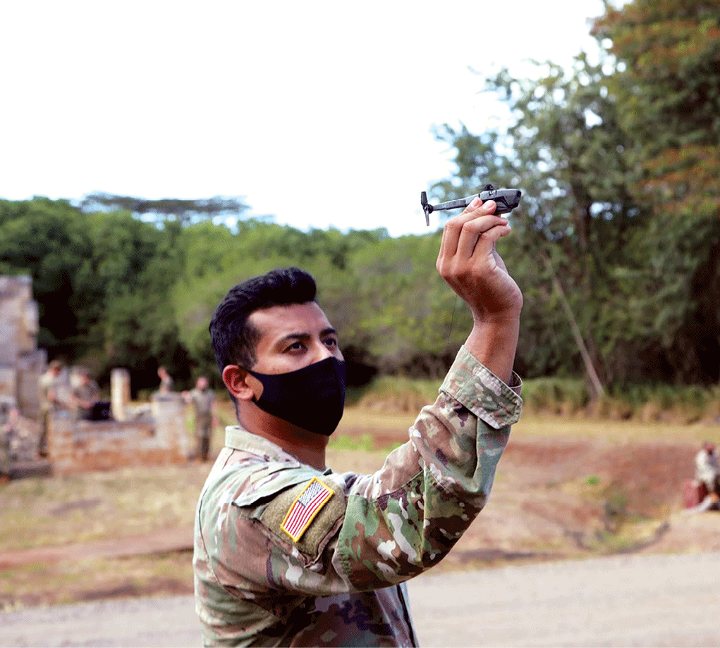 A Warrior Brigade soldier prepares a Black Hornet soldier-borne sensor for employment