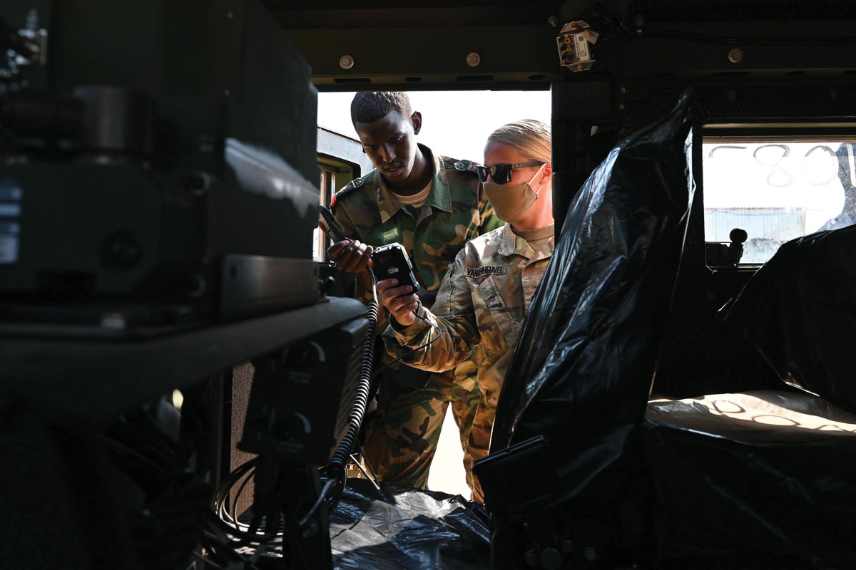 Staff Sgt. Marissa Vandenheuvel, Security Forces Assistance Brigade (SFAB) signal advisor, Combined Joint Task Force–Horn of Africa (CJTF-HOA), and a member from the Armed Forces of Djibouti (FAD) Battalion d’Intervention Rapide (BIR)