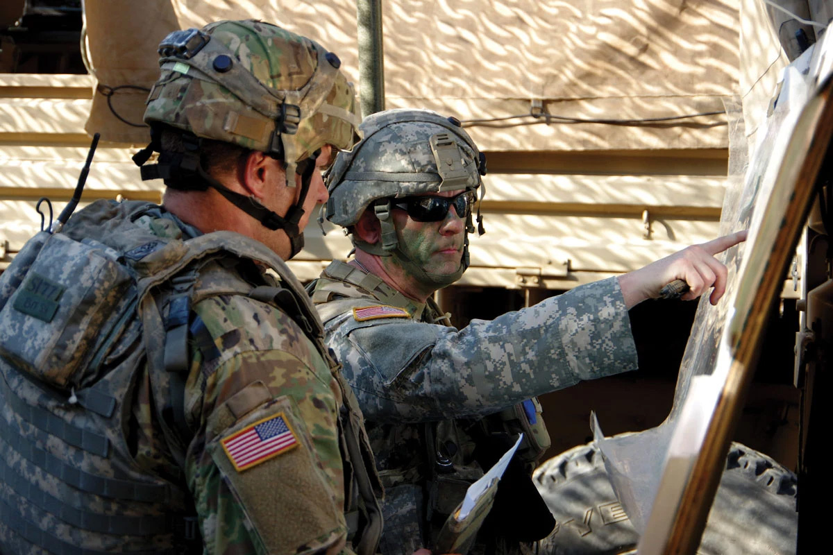 A soldier gives a mission briefing to a team member 12 May 2018